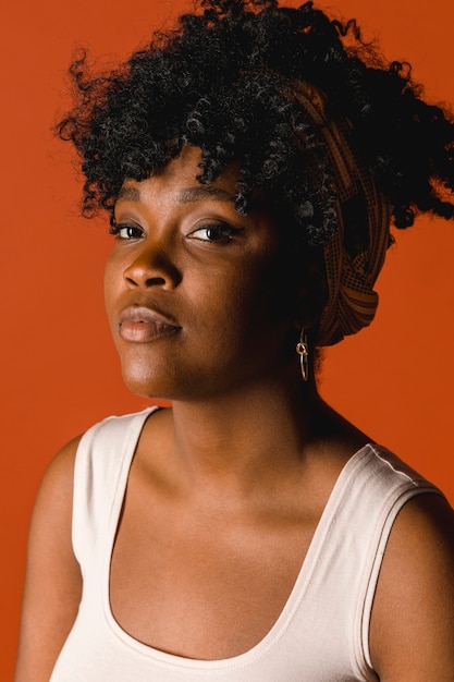 Serious ethnic curly young female in t-shirt in studio