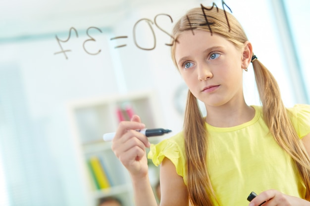 Free photo serious girl solving maths sums