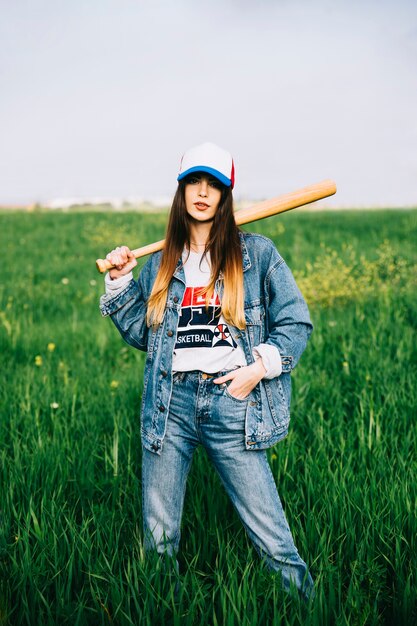 Free photo serious lady in jeans in field