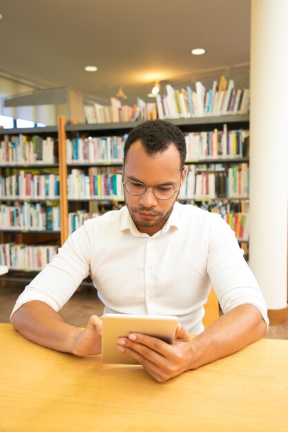 Serious male user using wireless internet connection