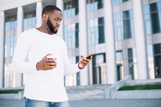 Serious man using smartphone