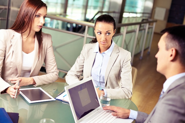 Serious manager listening to employee