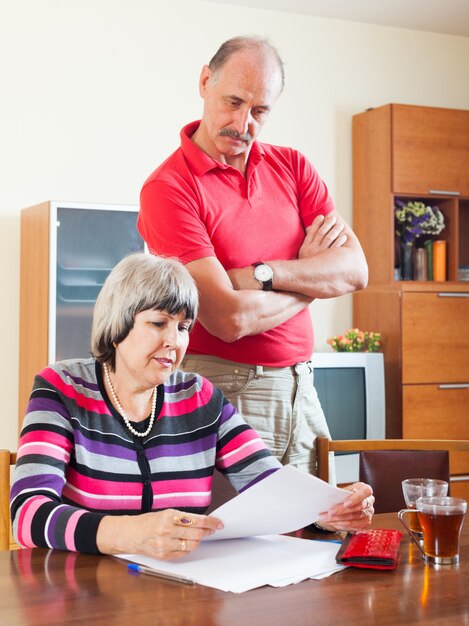 serious mature couple reading  document