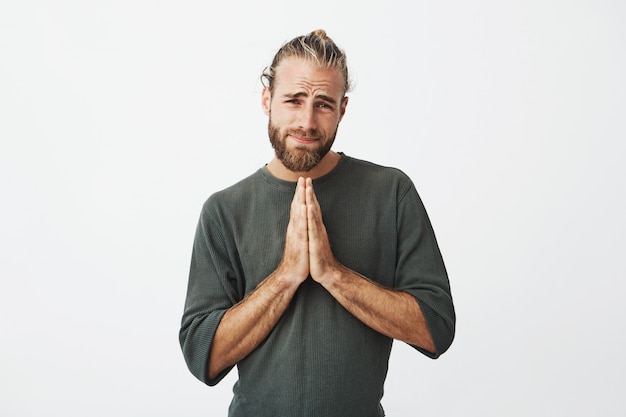 Free photo serious mature swedish guy feeling extremely guilty, asking to forgive