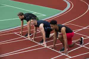 Free photo serious multiethnic athlete group ready to run