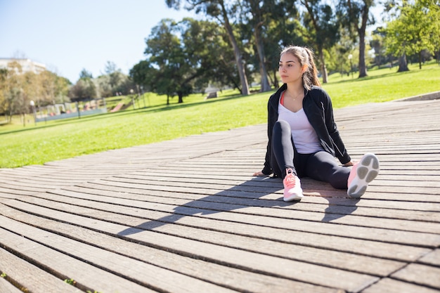 Free photo serious sporty lady relaxing outdoors