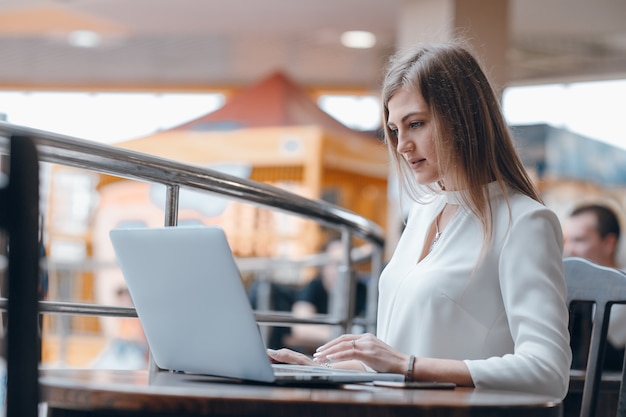 Serious woman looking at a laptop