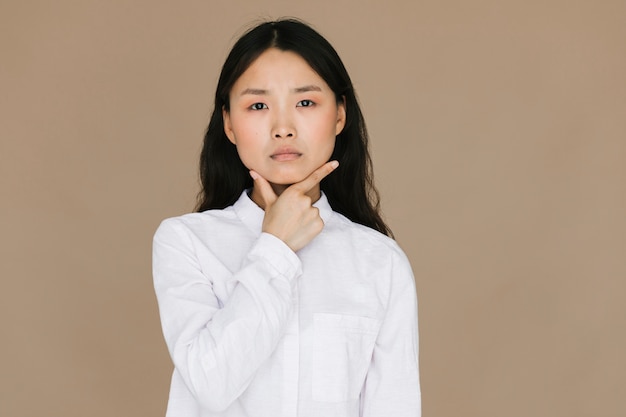 Serious woman with brown background