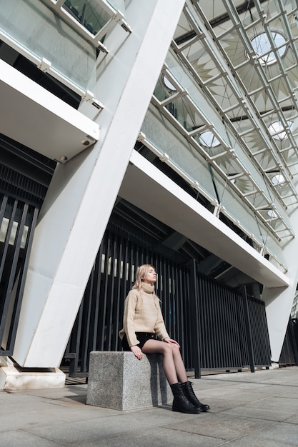 Free Photo serious young blonde lady outdoors with eyes closed.