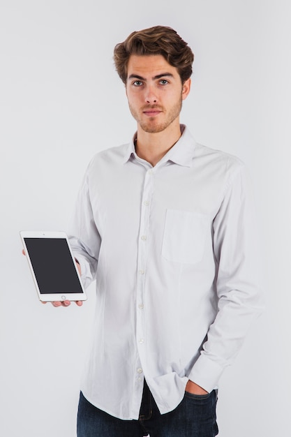 Free Photo serious young man posing with tablet