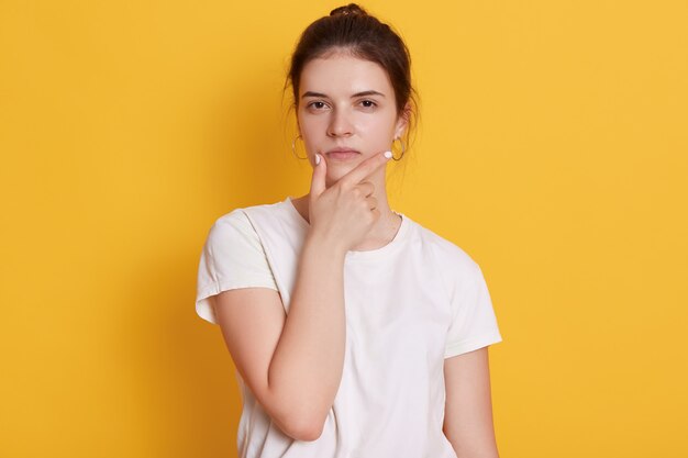 Serious young young woman wearing white t shirt