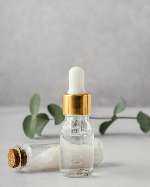 Free photo serum bottle, salt and plant