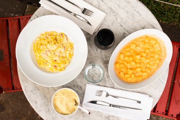 Serve italian pasta dishes on marble table in restaurant