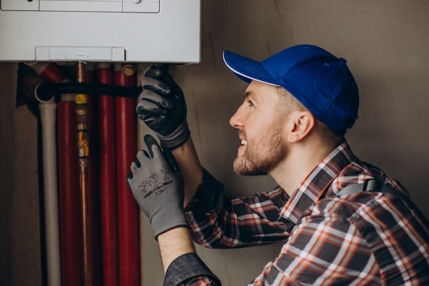 Service man adjusting house heating system