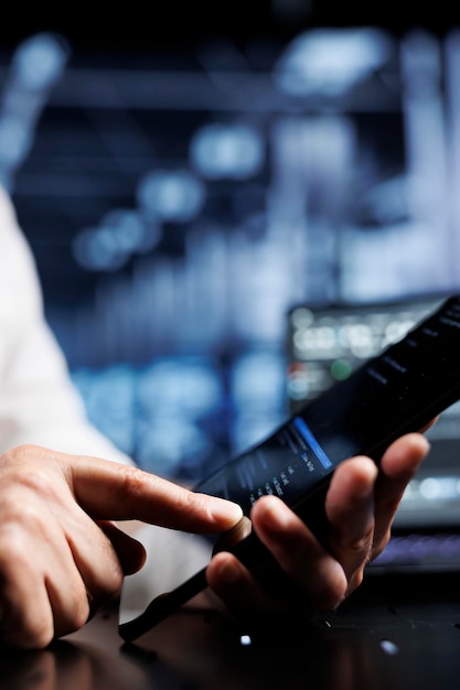 Free Photo serviceman coding in high tech data center using javascript language, close up. meticulous repairman updating software on server rigs on tablet terminal, ensuring optimal performance and security