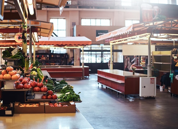 Sesonal vegetable market with variety of agriculture products on the shelfs and in the boxes.