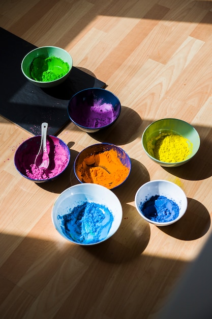 Free photo set of bowls with bright dry colors on floor