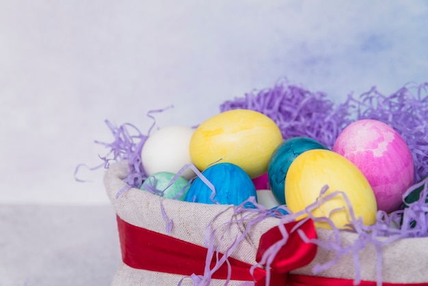 Set of bright Easter eggs in decorated basket