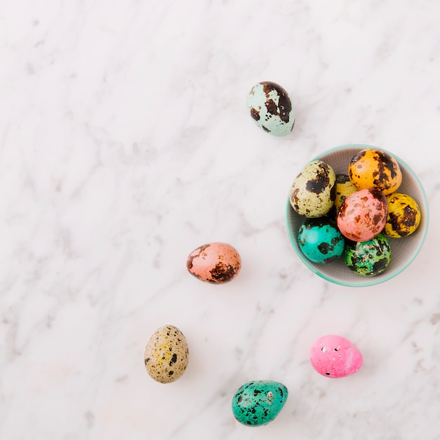 Set of colourful quail Easter eggs in bowl