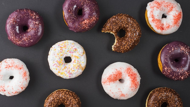 Set of delicious sweet bitten donuts with colorful coating