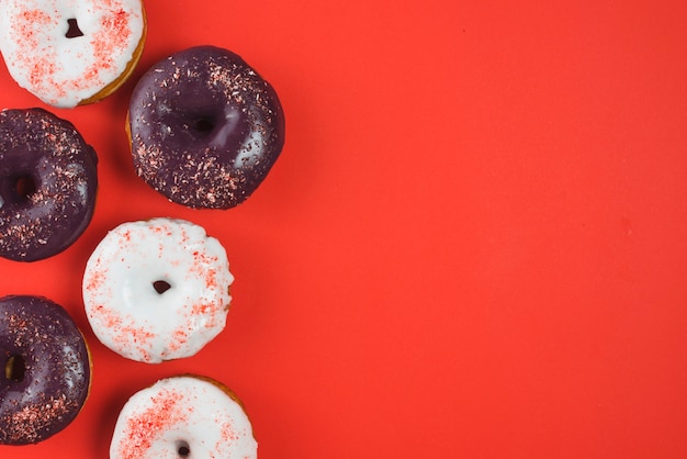 Free photo set of different colored round frosted donuts