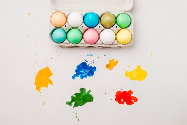 Free photo set of easter eggs in container near blurs of bright colors