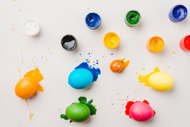 Free Photo set of easter eggs near water colors