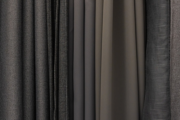 Set of grey dense fabrics of uniform texture, choice of materials in grey colors.