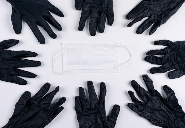 Free Photo set of medical mask and medical gloves on a white background. top view.