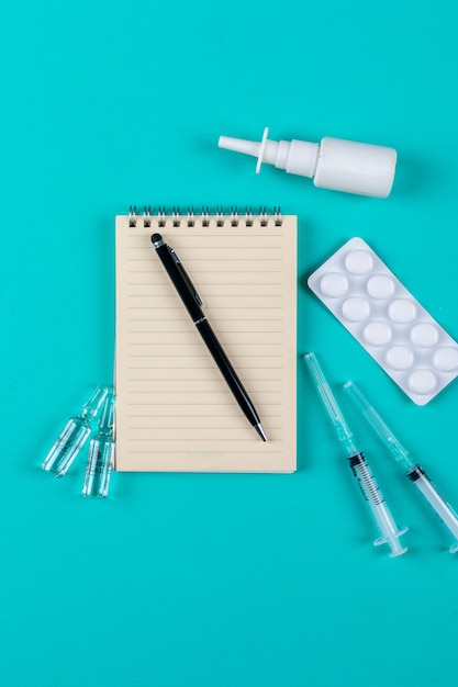 Set of notepad, pen, needles, nasal spray and pills