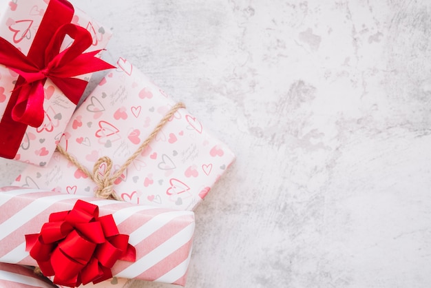 Set of present boxes in wrap with red ribbon, bow and twist