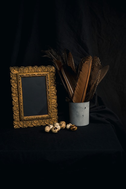 Set of quail eggs near feathers in can and photo frame