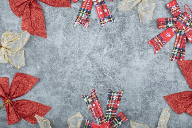 Set of red and golden ribbons on marble surface