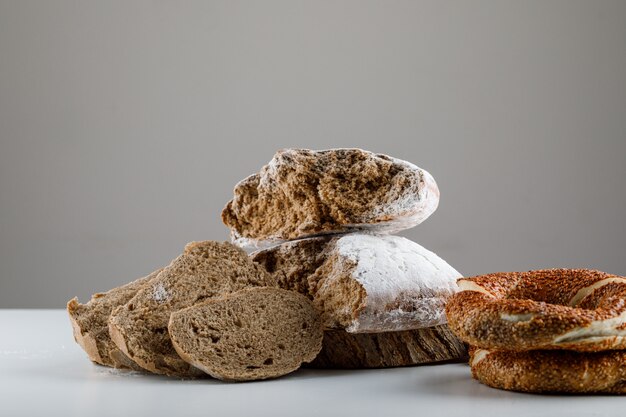 Set of turkish bagel and sliced bread on a white and gray surface. side view.