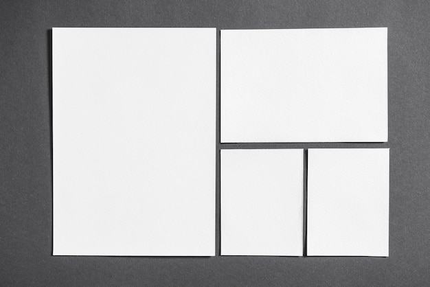 Free Photo set of vivid blank white papers on grey background