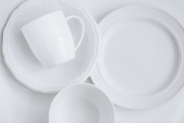 Free photo set of white utensils from three different plates and a cup in a plate