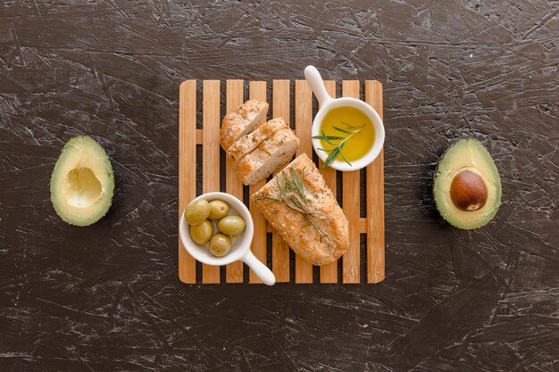 Set with bread olives and oil on board