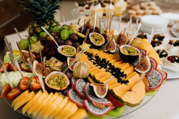 Free photo set with variety of exotic fruits, cutted on the plate, banquet buffet