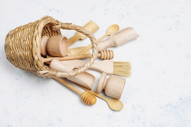 Free Photo set of wooden kitchen utensils on concrete surface