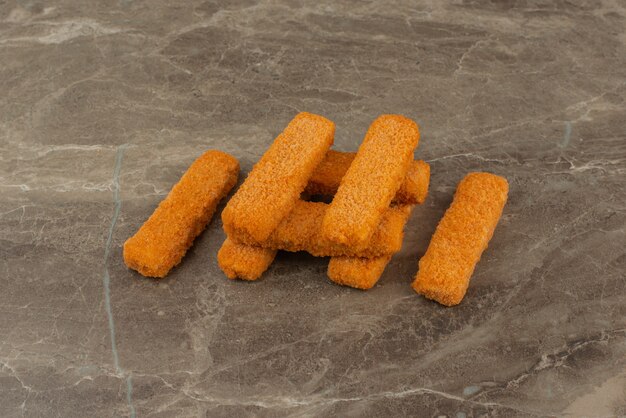 Several chicken nuggets on marble table .