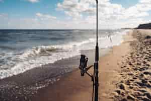 Free photo several fishing rods in a row on the beach