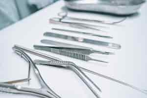 Free photo several surgical instruments lie on a white table