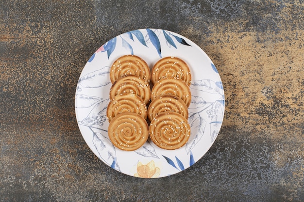 Several tasty biscuits on colorful plate.