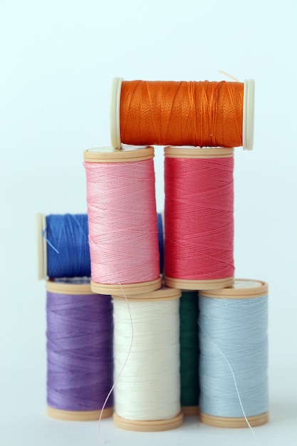 Sewing. Colorful threads on a white background