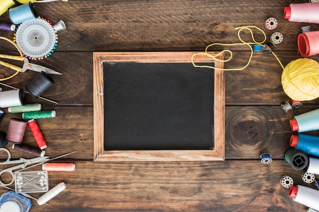 Free photo sewing tools near chalkboard