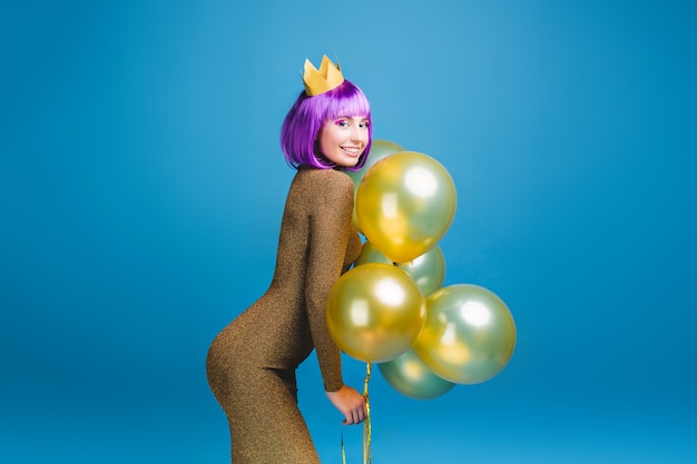 Free photo sexy beautiful young woman in fashionable luxury dress having fun with golden balloons . cut purple hair, crown, celebrating new year party, birthday, smiling, happiness.