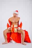 Free photo sexy santa man isolated on white background