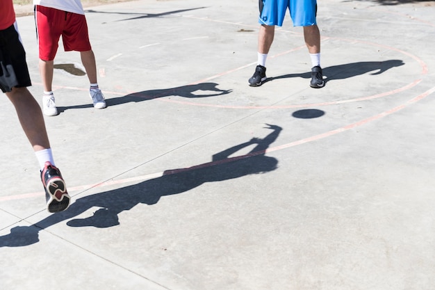 Shadow of basketball player on an outdoors court