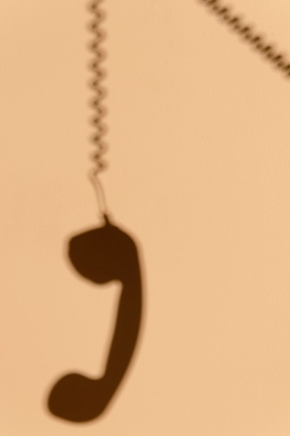 Free photo shadow of a telephone on the wall