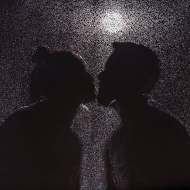 Free photo shadows of kissing man and woman